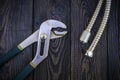 Plumbing tools for connecting water hoses on a black wooden background Royalty Free Stock Photo