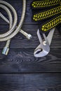 Plumbing tools for connecting water hoses on a black wooden background Royalty Free Stock Photo