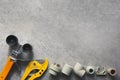 Plumbing tools on gray background with copy space. Soldering iron scissors and fittings pp and pvc