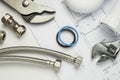 Plumbing tools and parts on house plans Royalty Free Stock Photo