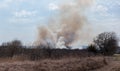 Plumes of smoke from a range-burning grass fire in rural Kansas