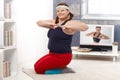 Plump female doing workout at home