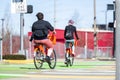 Plump guy and slim girl ride rented bicycles in the city rental station