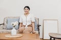 Plump and healthy housewife sitting in the home living room warm smiling, looking at the camera