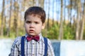 Plump little boy in shirt and bow tie looks