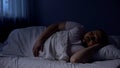 Plump man sleeping in bed, relaxing at night on comfortable mattress, rest Royalty Free Stock Photo