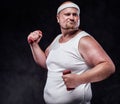 A plump man works out with two small dumbbells. Royalty Free Stock Photo