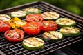 plump tomatoes and zucchini slices on a grill Royalty Free Stock Photo