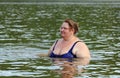 Plump woman bath in river Royalty Free Stock Photo