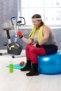 Plump woman exercising with dumbbells Royalty Free Stock Photo