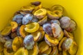 Plums harvest.Plum halves background.Yellow pulp of fruits in a yellow cup. Juicy pulp texture.Farm organic fruits.Plums Royalty Free Stock Photo