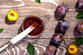 Plums and jam of plum on wood background tanle