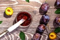 Plums and jam of plum on wood background tanle Royalty Free Stock Photo