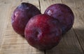 Plums over rustic wooden table Royalty Free Stock Photo