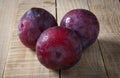 Plums over rustic wooden table Royalty Free Stock Photo