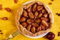 Plums pie with raisins on a white plate on yellow wooden background decorated with fresh plums, brown raisins Royalty Free Stock Photo