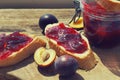 Plums and plum jam on a wooden board Royalty Free Stock Photo