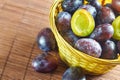 Plums in weaved basket Royalty Free Stock Photo