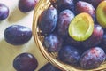 Plums in weaved basket Royalty Free Stock Photo