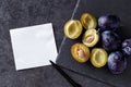 Plums, whole and slices with blank card add own text Royalty Free Stock Photo