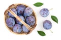 Plums in wicker basket isolated on a white background. Top view. Flat lay pattern Royalty Free Stock Photo