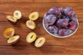 Plums on wood, halfed Royalty Free Stock Photo
