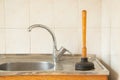 The plunger stands at the sink in the kitchen, cleaning clogged pipes, plunger for cleaning pipes Royalty Free Stock Photo