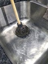 Plunger unclogging sink drain