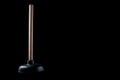 Plunger with wooden handle and rubber tip on a black background, isolate