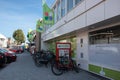 Plus food grocery store entrance and facade with branding and flags with logo