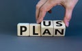 Plus plan. Male hand turns wooden cubes with words `plus plan`. Beautiful grey background, copy space. Business and plus plan