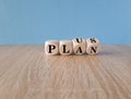 Plus, plan. Turned wooden cubes with words plus plan. Beautiful blue background,wooden table. Copy space. Business and plus plan