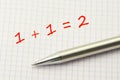 1 plus 1. Simple equation on a squared paper sheet. Math for children Royalty Free Stock Photo