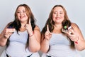 Plus size caucasian sisters woman holding slice of cake smiling with an idea or question pointing finger with happy face, number