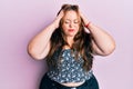 Plus size caucasian young woman wearing casual clothes with hand on head, headache because stress