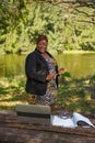 Plus size CEO businesswoman boss giving a speech in an online group meeting. She is working remotely in the park