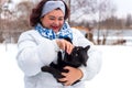 Woman at winter snowy day at walk with a cat Royalty Free Stock Photo