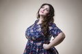 Plus size fashion model in casual clothes, fat woman on beige background, overweight female body Royalty Free Stock Photo