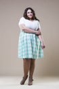 Plus size fashion model in casual clothes, fat woman on beige studio background, overweight female body Royalty Free Stock Photo