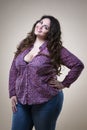 Plus size fashion model in casual clothes, fat woman on beige studio background, overweight female body Royalty Free Stock Photo