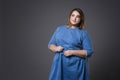 Plus size fashion model in casual clothes, fat woman on gray background, overweight female body Royalty Free Stock Photo