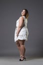 Plus size fashion model in casual clothes, fat woman on gray background, overweight female body Royalty Free Stock Photo