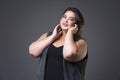 Plus size fashion model in casual clothes, fat woman on gray background, overweight female body Royalty Free Stock Photo