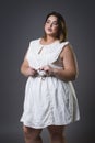 Plus size fashion model in casual clothes, fat woman on gray background, overweight female body Royalty Free Stock Photo