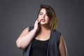 Plus size fashion model in casual clothes, fat woman on gray background, overweight female body Royalty Free Stock Photo