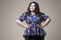 Plus size fashion model in casual clothes, fat woman on studio background, overweight female body