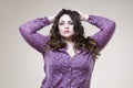 Plus size fashion model, fat woman on beige background