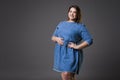 Plus size fashion model in casual jeans clothes, fat woman on gray background, overweight female body Royalty Free Stock Photo