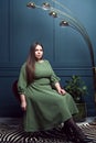 Plus size fashion model in a dress, woman on studio background, overweight female body