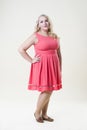 Plus size fashion model, fat woman on beige background, overweight female body